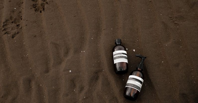 Brand Voice - Two bottles of water laying on the sand